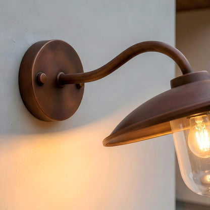 Luxury home exterior featuring a bronze outdoor wall light that creates warm and elegant illumination around the entrance area.