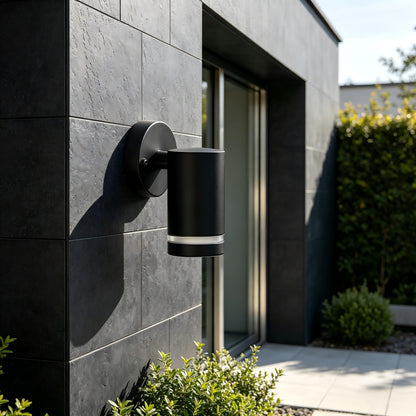 Illuminated black outdoor cylinder light at front gate entrance wide night view