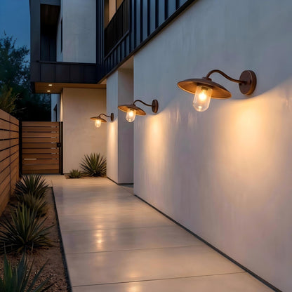 Modern bronze outdoor wall light installed beside a front door, creating warm and inviting exterior lighting for a contemporary home.