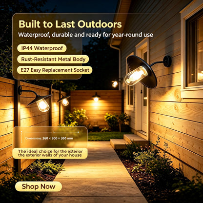 Close-up of the Sunsatu black outdoor sconce glowing warmly against a dark background, showcasing the light beam.
