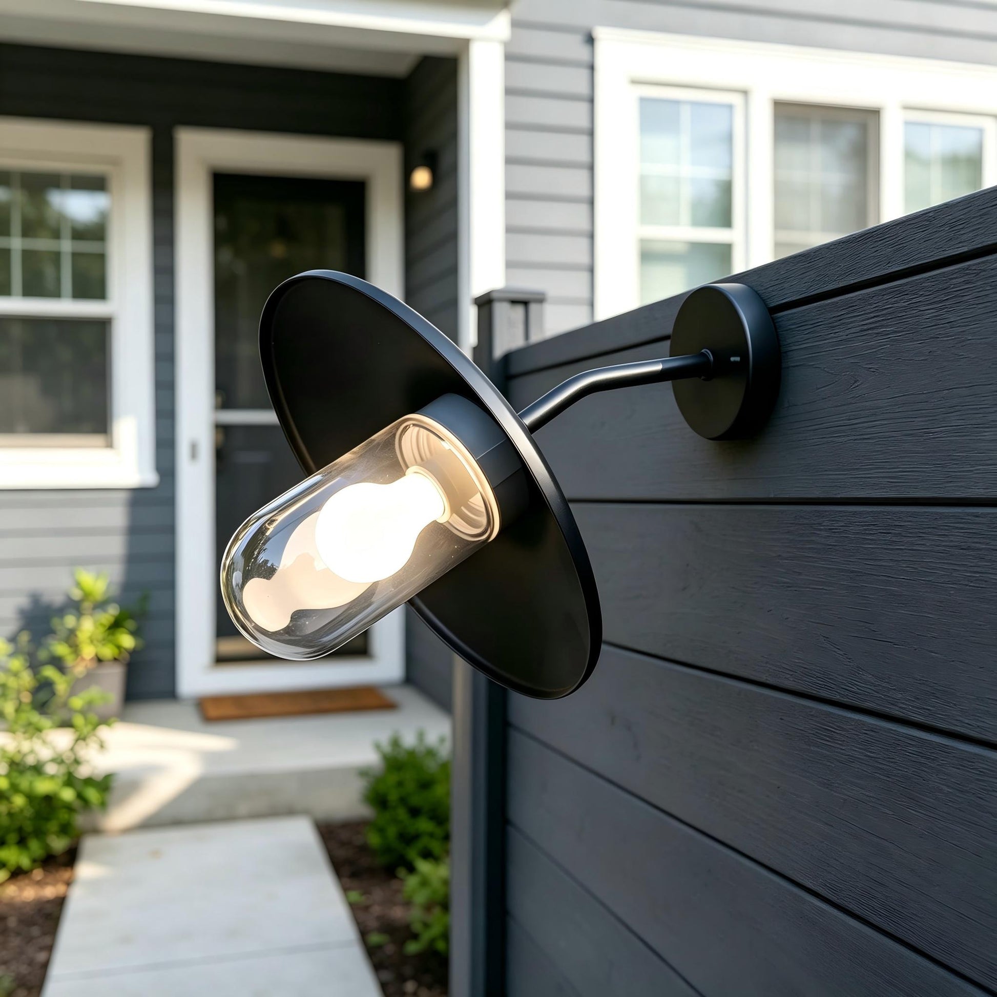 Detailed view of the clear capsule glass shade and the weatherproof seal on the Sunsatu exterior sconce.